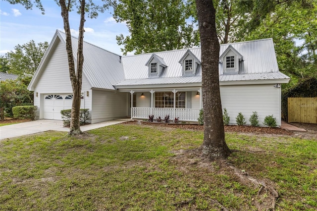 10943 NW 34th Pl, Gainesville, FL 32606 - view of front of property with a porch, concrete driveway, a garage, and a metal roof