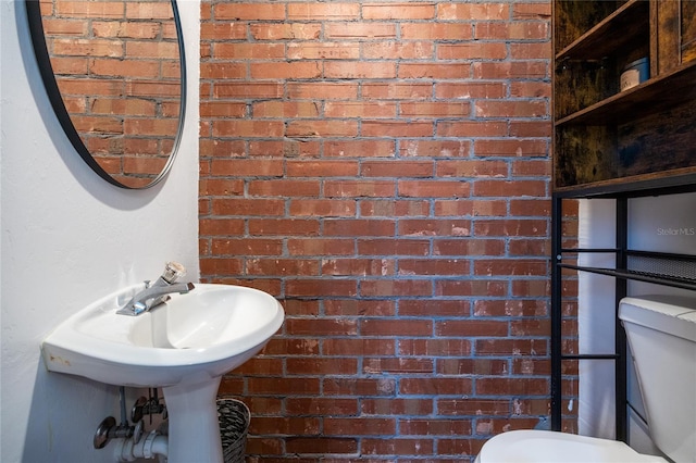 9911 NW 24th Pl, Gainesville, FL 32606 - half bathroom with toilet and brick wall