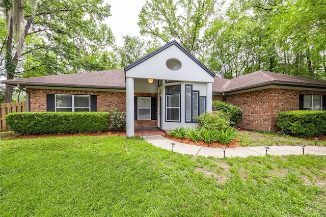 9911 NW 24th Pl, Gainesville, FL 32606 - view of front of house featuring brick siding and roof with shingles