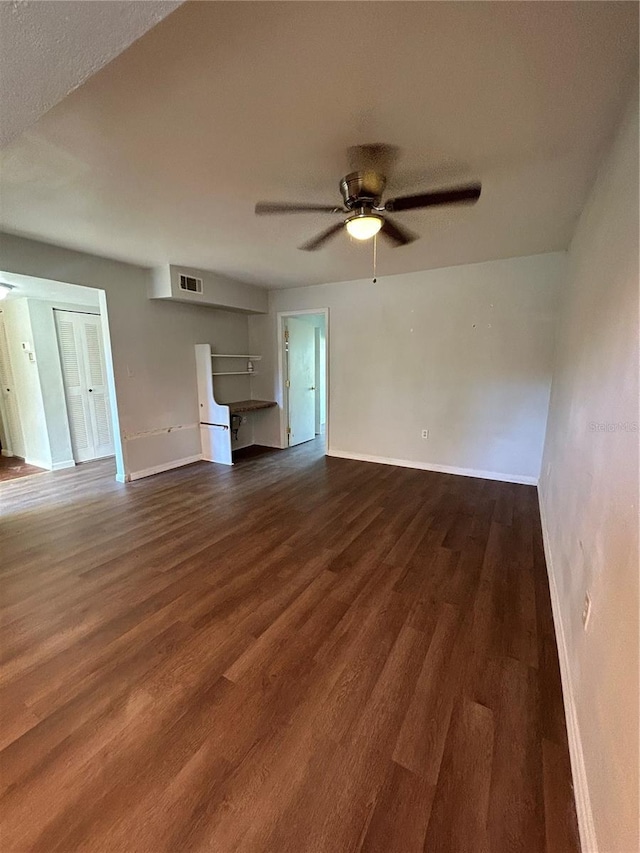2811 SW Archer Rd Unit X203, Gainesville, FL 32608 - unfurnished living room featuring dark wood-style floors and a ceiling fan