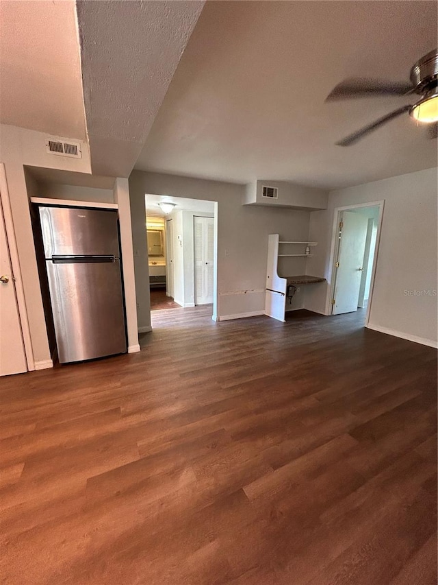 2811 SW Archer Rd Unit X203, Gainesville, FL 32608 - unfurnished living room featuring a ceiling fan, wood finished floors, and a textured ceiling