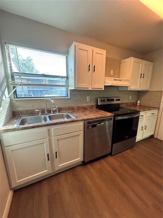 2811 SW Archer Rd Unit X203, Gainesville, FL 32608 - kitchen featuring stainless steel appliances, under cabinet range hood, dark wood-type flooring, white cabinetry, and tasteful backsplash