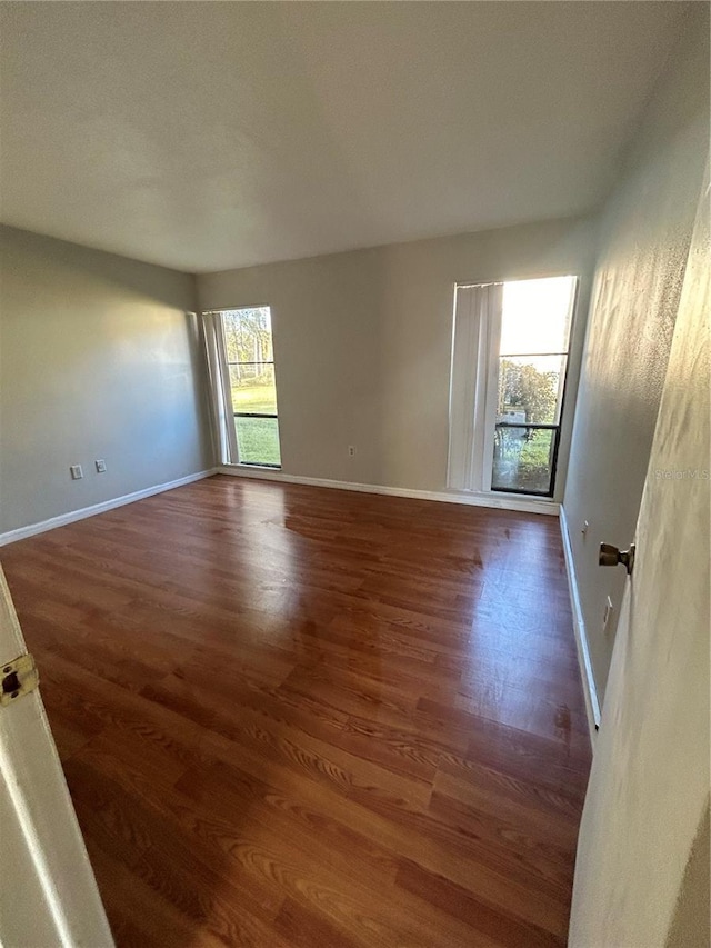 2811 SW Archer Rd Unit X203, Gainesville, FL 32608 - unfurnished room featuring plenty of natural light and wood finished floors
