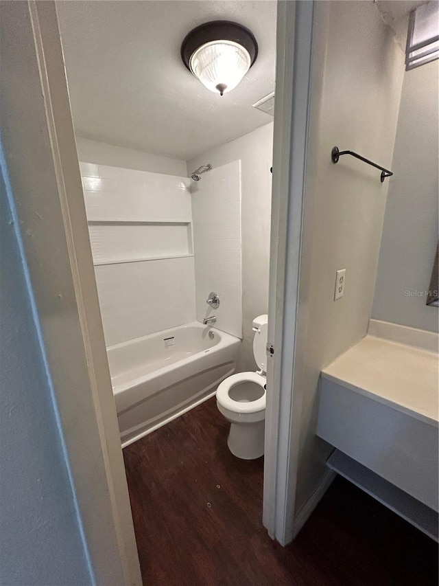 2811 SW Archer Rd Unit X203, Gainesville, FL 32608 - bathroom featuring wood finished floors and washtub / shower combination