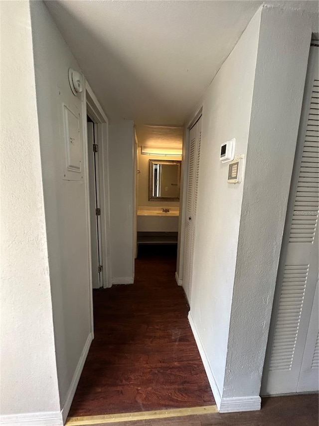 2811 SW Archer Rd Unit X203, Gainesville, FL 32608 - corridor featuring wood finished floors and baseboards