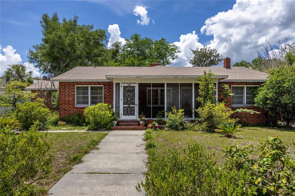 718 NE 3rd St, Gainesville, FL 32601 - ranch-style house with brick siding and a chimney