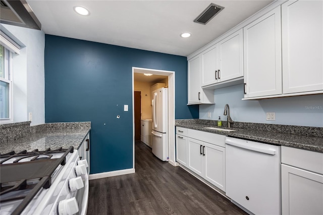 1814 NE 7th St, Gainesville, FL 32609 - kitchen featuring white appliances, dark wood-type flooring, white cabinetry, recessed lighting, and dark stone counters