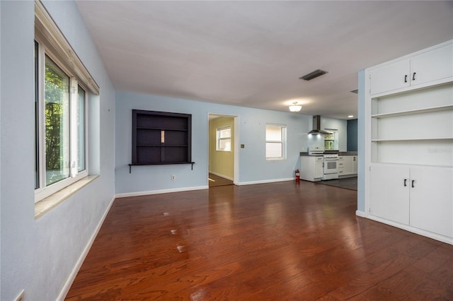 1814 NE 7th St, Gainesville, FL 32609 - unfurnished living room with built in features and dark wood finished floors