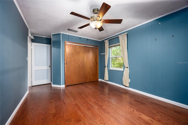 1814 NE 7th St, Gainesville, FL 32609 - unfurnished bedroom featuring wood finished floors, a closet, ornamental molding, and ceiling fan