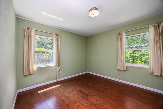 1814 NE 7th St, Gainesville, FL 32609 - unfurnished room featuring dark wood-type flooring and baseboards
