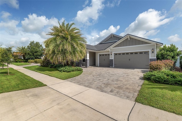 11890 SW 33rd Ln, Gainesville, FL 32608 - craftsman house featuring board and batten siding, a garage, decorative driveway, and a front yard
