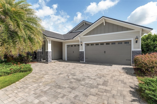 11890 SW 33rd Ln, Gainesville, FL 32608 - craftsman inspired home with stone siding, board and batten siding, a garage, and decorative driveway