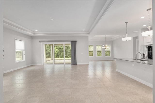11890 SW 33rd Ln, Gainesville, FL 32608 - unfurnished living room featuring a tray ceiling, light tile patterned floors, recessed lighting, and crown molding