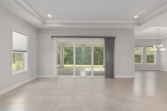 11890 SW 33rd Ln, Gainesville, FL 32608 - spare room with a raised ceiling, plenty of natural light, light tile patterned floors, crown molding, and a chandelier