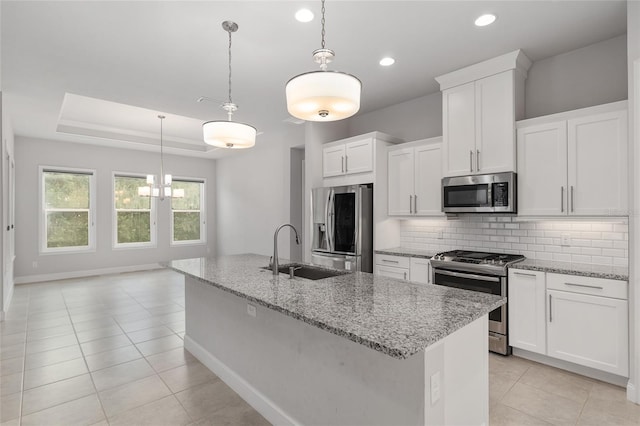11890 SW 33rd Ln, Gainesville, FL 32608 - kitchen with stainless steel appliances, light tile patterned floors, tasteful backsplash, recessed lighting, and white cabinets