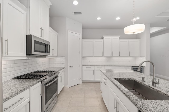 11890 SW 33rd Ln, Gainesville, FL 32608 - kitchen featuring stainless steel appliances, backsplash, white cabinets, and recessed lighting