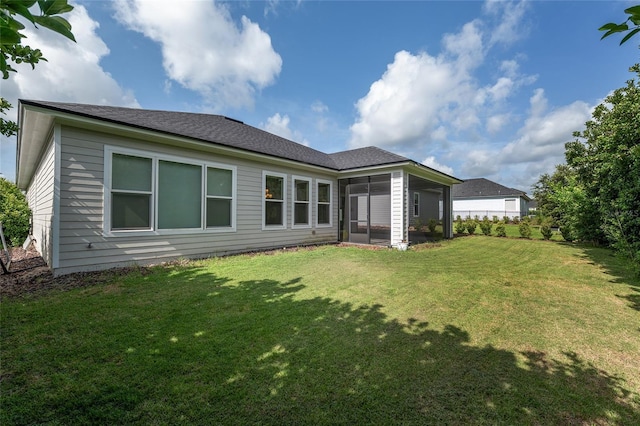11890 SW 33rd Ln, Gainesville, FL 32608 - rear view of house featuring a lawn, a sunroom, and roof with shingles