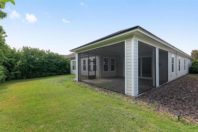 11890 SW 33rd Ln, Gainesville, FL 32608 - view of home's exterior with a patio, a yard, and a sunroom
