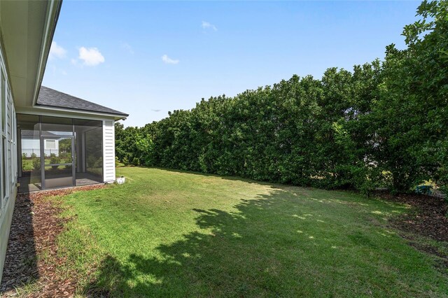 11890 SW 33rd Ln, Gainesville, FL 32608 - view of green lawn with a sunroom