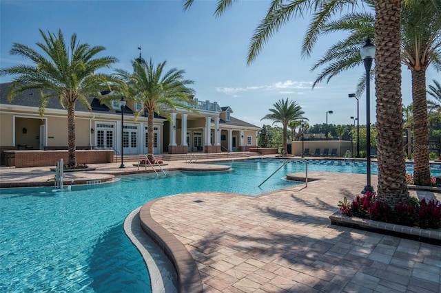 11890 SW 33rd Ln, Gainesville, FL 32608 - community pool with french doors and a patio area