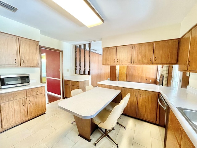 2268 NW 17th Ave, Gainesville, FL 32605 - kitchen featuring stainless steel appliances, light countertops, healthy amount of natural light, and brown cabinets