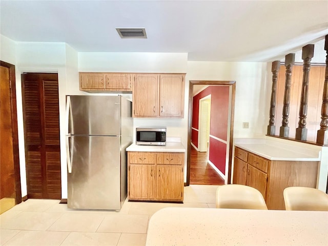 2268 NW 17th Ave, Gainesville, FL 32605 - kitchen with appliances with stainless steel finishes, light tile patterned floors, and light countertops