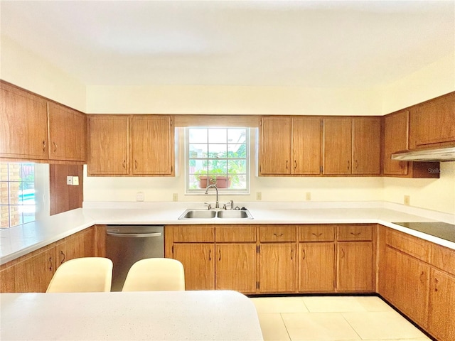 2268 NW 17th Ave, Gainesville, FL 32605 - kitchen featuring stainless steel dishwasher, under cabinet range hood, light countertops, brown cabinetry, and light tile patterned flooring