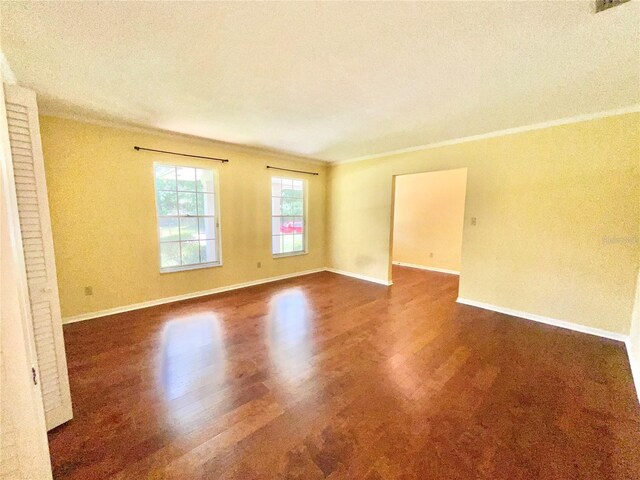 2268 NW 17th Ave, Gainesville, FL 32605 - spare room featuring dark wood-style flooring and crown molding