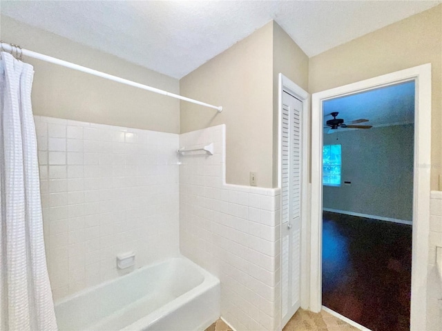 2268 NW 17th Ave, Gainesville, FL 32605 - bathroom with shower / bathtub combination with curtain, a ceiling fan, tile walls, and a wainscoted wall