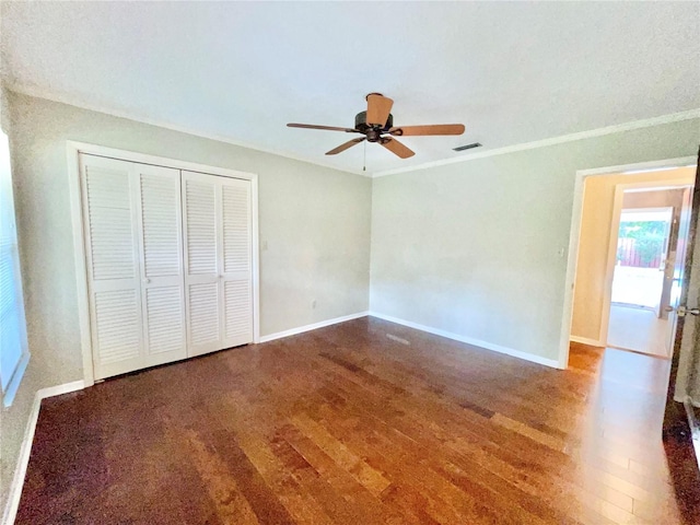2268 NW 17th Ave, Gainesville, FL 32605 - unfurnished bedroom featuring wood finished floors, a closet, ceiling fan, and crown molding