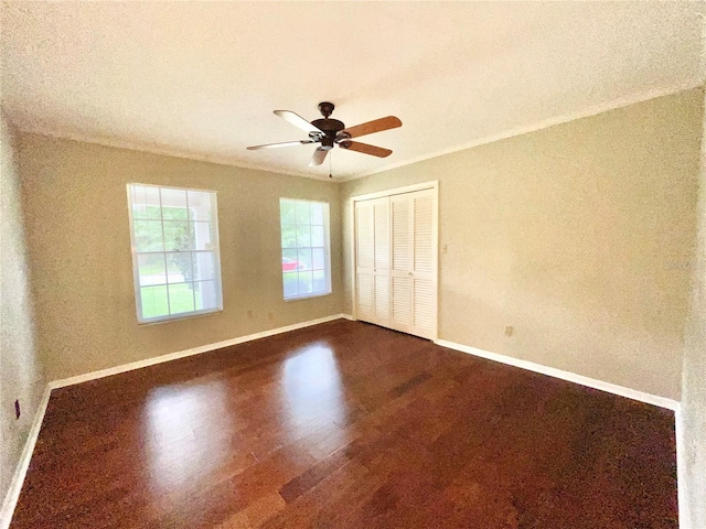 2268 NW 17th Ave, Gainesville, FL 32605 - unfurnished bedroom with dark wood finished floors, a closet, a ceiling fan, and crown molding
