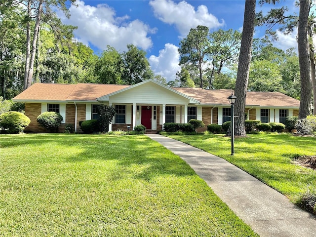 2268 NW 17th Ave, Gainesville, FL 32605 - ranch-style house featuring a front lawn, brick siding, and a porch