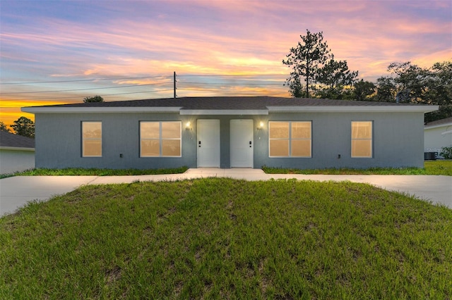 9011 N Travis Dr, Citrus Springs, FL 34434 - view of front facade featuring a yard and stucco siding