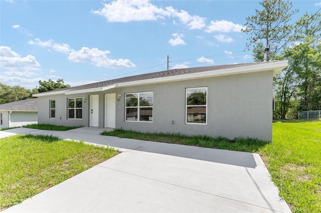 9011 N Travis Dr, Citrus Springs, FL 34434 - single story home with a front yard, stucco siding, a patio area, and a shingled roof
