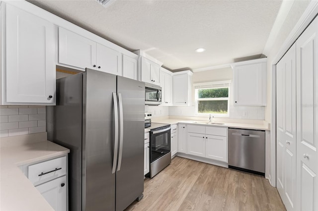 9011 N Travis Dr, Citrus Springs, FL 34434 - kitchen with stainless steel appliances, backsplash, white cabinets, a textured ceiling, and recessed lighting