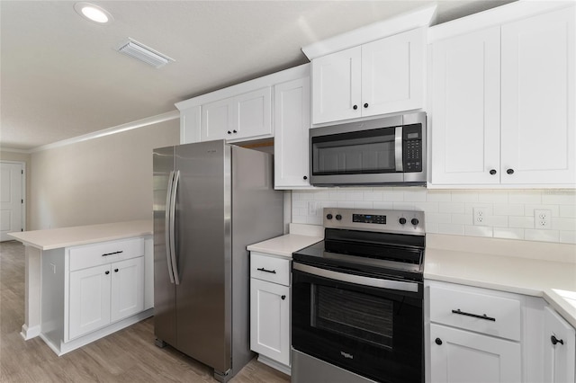 9011 N Travis Dr, Citrus Springs, FL 34434 - kitchen with appliances with stainless steel finishes, light wood-type flooring, backsplash, light countertops, and ornamental molding