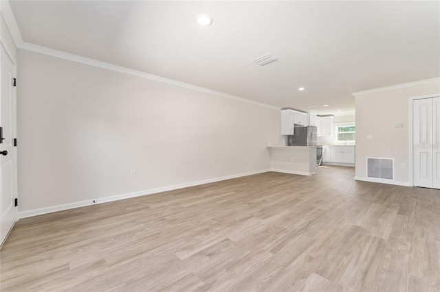 9011 N Travis Dr, Citrus Springs, FL 34434 - unfurnished living room featuring ornamental molding, light wood finished floors, and recessed lighting