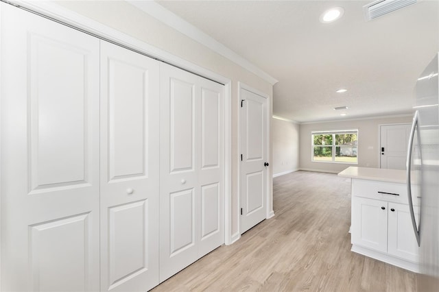 9011 N Travis Dr, Citrus Springs, FL 34434 - corridor featuring crown molding, light wood-style flooring, and recessed lighting