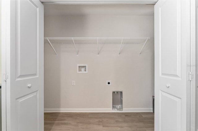 9011 N Travis Dr, Citrus Springs, FL 34434 - laundry area featuring hookup for a washing machine, wood finished floors, and electric dryer hookup
