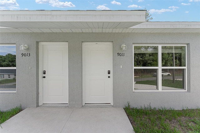 9011 N Travis Dr, Citrus Springs, FL 34434 - doorway to property featuring stucco siding