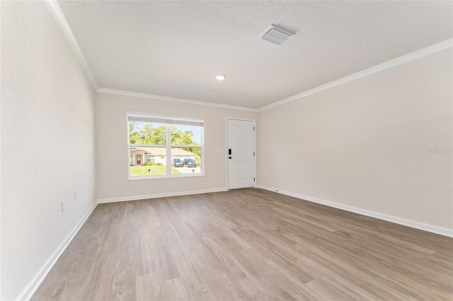 9011 N Travis Dr, Citrus Springs, FL 34434 - empty room featuring ornamental molding, light wood-style flooring, and a textured ceiling
