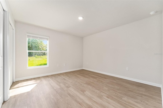 9011 N Travis Dr, Citrus Springs, FL 34434 - empty room featuring light wood-style floors, a smoke detector, and recessed lighting