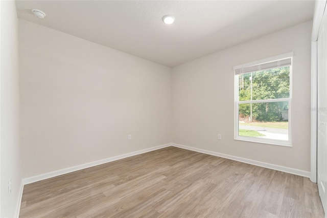 9011 N Travis Dr, Citrus Springs, FL 34434 - spare room featuring a smoke detector and light wood-style floors