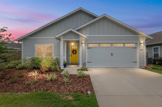 1425 SW 67th Dr, Gainesville, FL 32607 - view of front facade featuring an attached garage, driveway, and board and batten siding