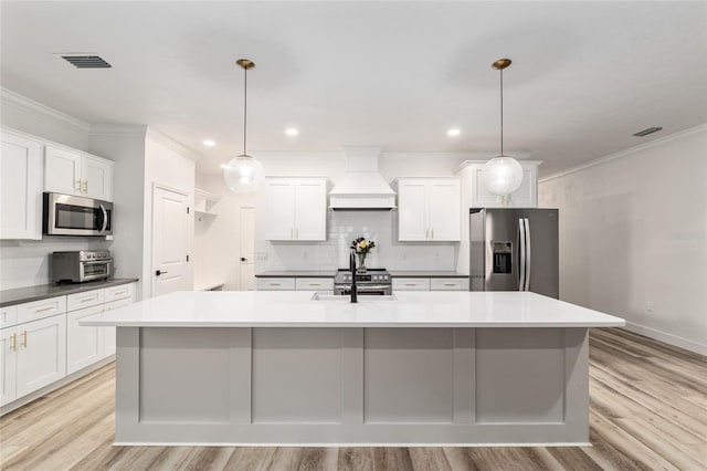 1425 SW 67th Dr, Gainesville, FL 32607 - kitchen with stainless steel appliances, premium range hood, decorative backsplash, light wood-style floors, and ornamental molding