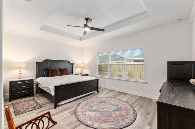 1425 SW 67th Dr, Gainesville, FL 32607 - bedroom featuring a tray ceiling, light wood finished floors, crown molding, and a ceiling fan