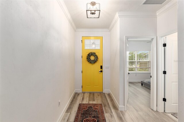 1425 SW 67th Dr, Gainesville, FL 32607 - doorway to outside with light wood-type flooring and crown molding