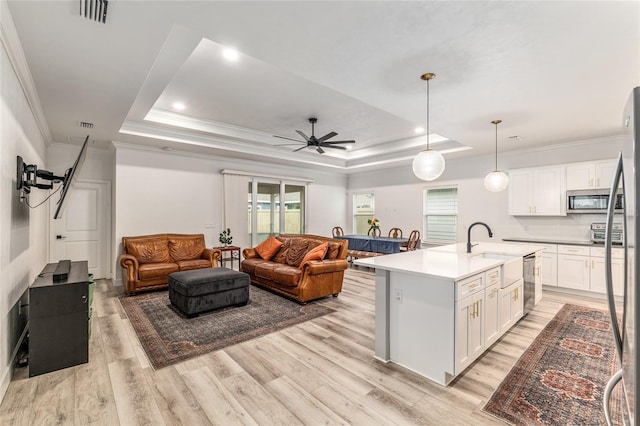 1425 SW 67th Dr, Gainesville, FL 32607 - kitchen with a tray ceiling, appliances with stainless steel finishes, healthy amount of natural light, crown molding, and recessed lighting