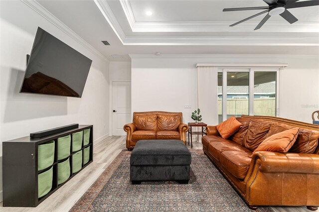 1425 SW 67th Dr, Gainesville, FL 32607 - living room featuring ceiling fan, wood finished floors, crown molding, and a tray ceiling