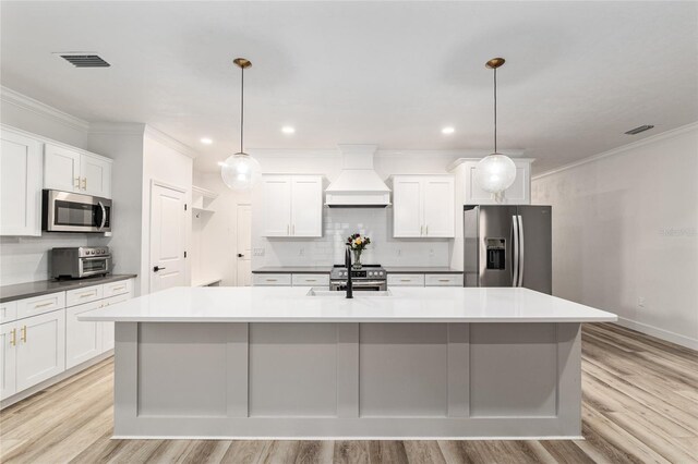 1425 SW 67th Dr, Gainesville, FL 32607 - kitchen with stainless steel appliances, premium range hood, decorative backsplash, light wood-style floors, and ornamental molding